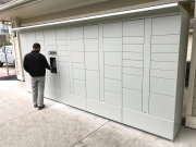 Man accessing outdoor package locker system