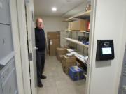 Man Holding Open Door of Package Room