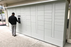 Man accessing outdoor package locker system Man accessing outdoor package locker system