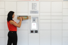 Woman Retrieving Box from Package Locker