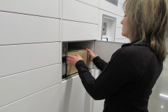 Woman Retrieving Parcel from Package Lockers