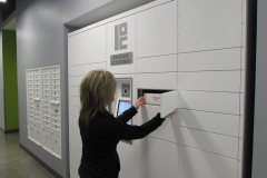 Woman Retrieving Package from White Powder Coat Smart Locker