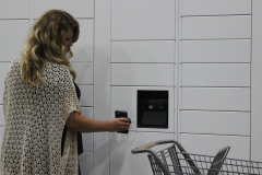 Woman Scanning Phone to Pick Up Order at Locker