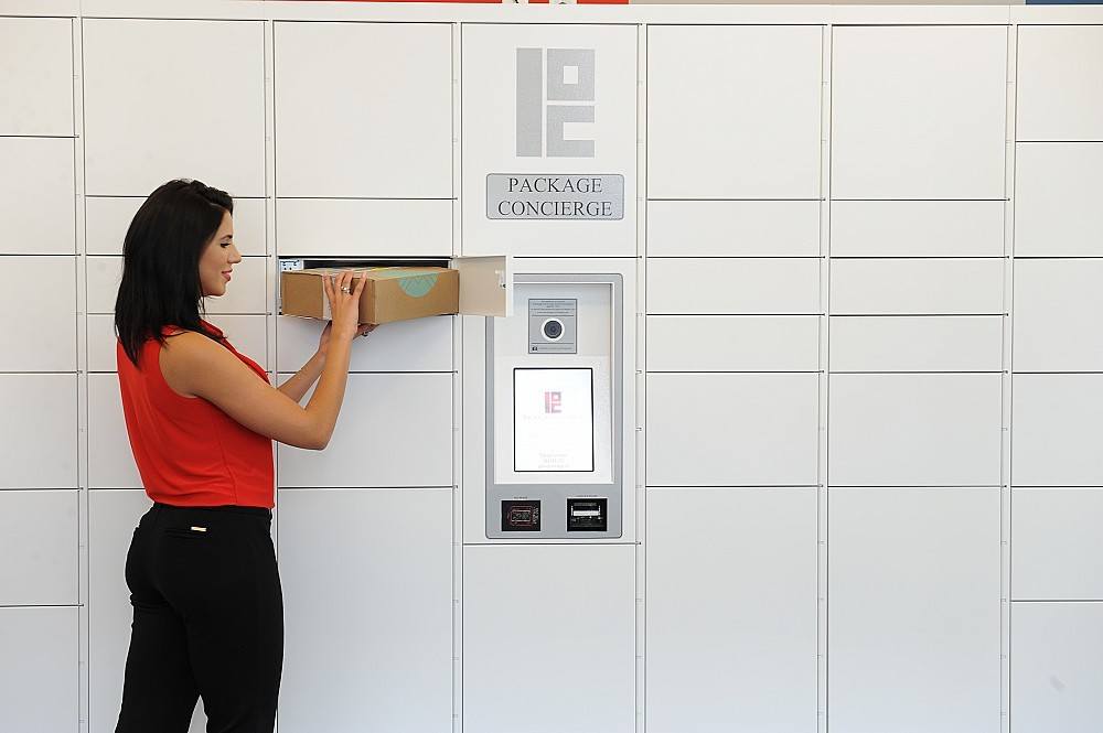 woman retrieving package from smart indoor lockers