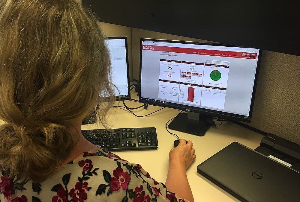 Woman facing computer monitor with charts