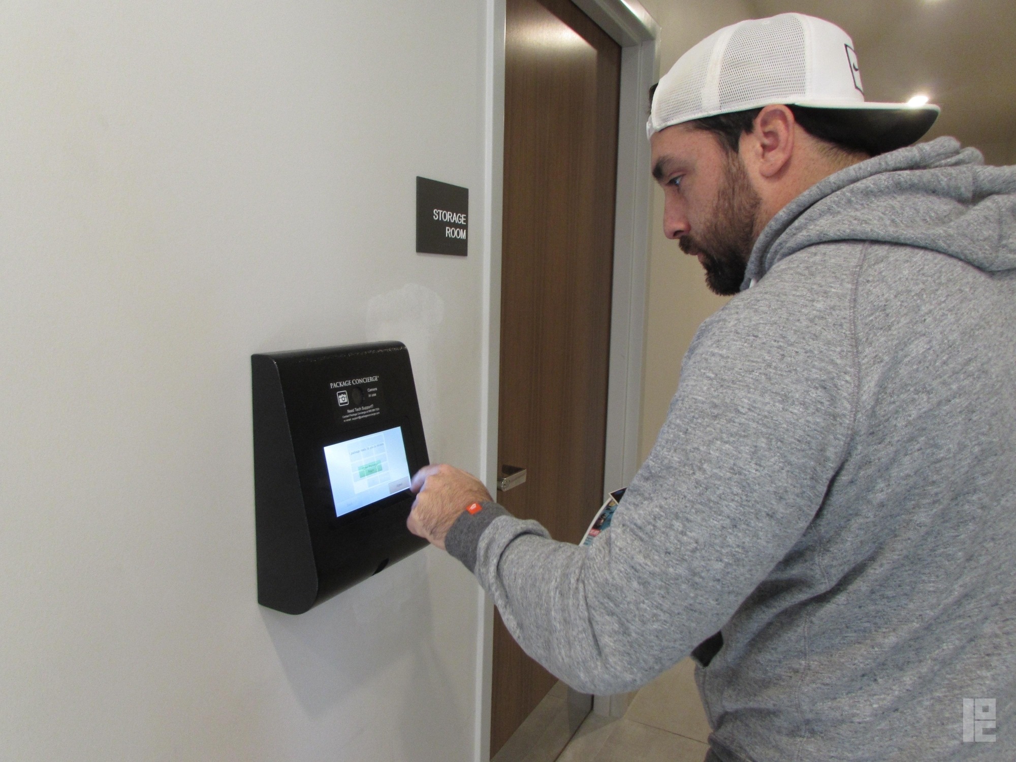 man using smart package room kiosk