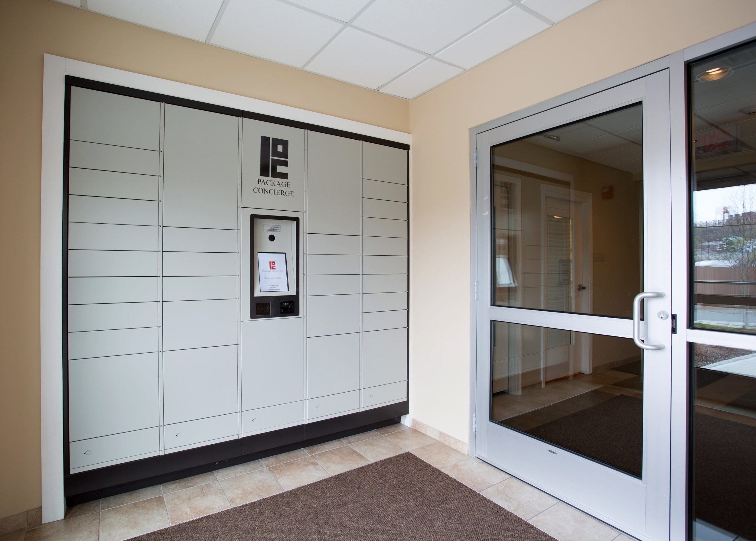 A Package Concierge® smart automated locker system installed in grey in a Chelsea Place apartment complex in Boston, MA