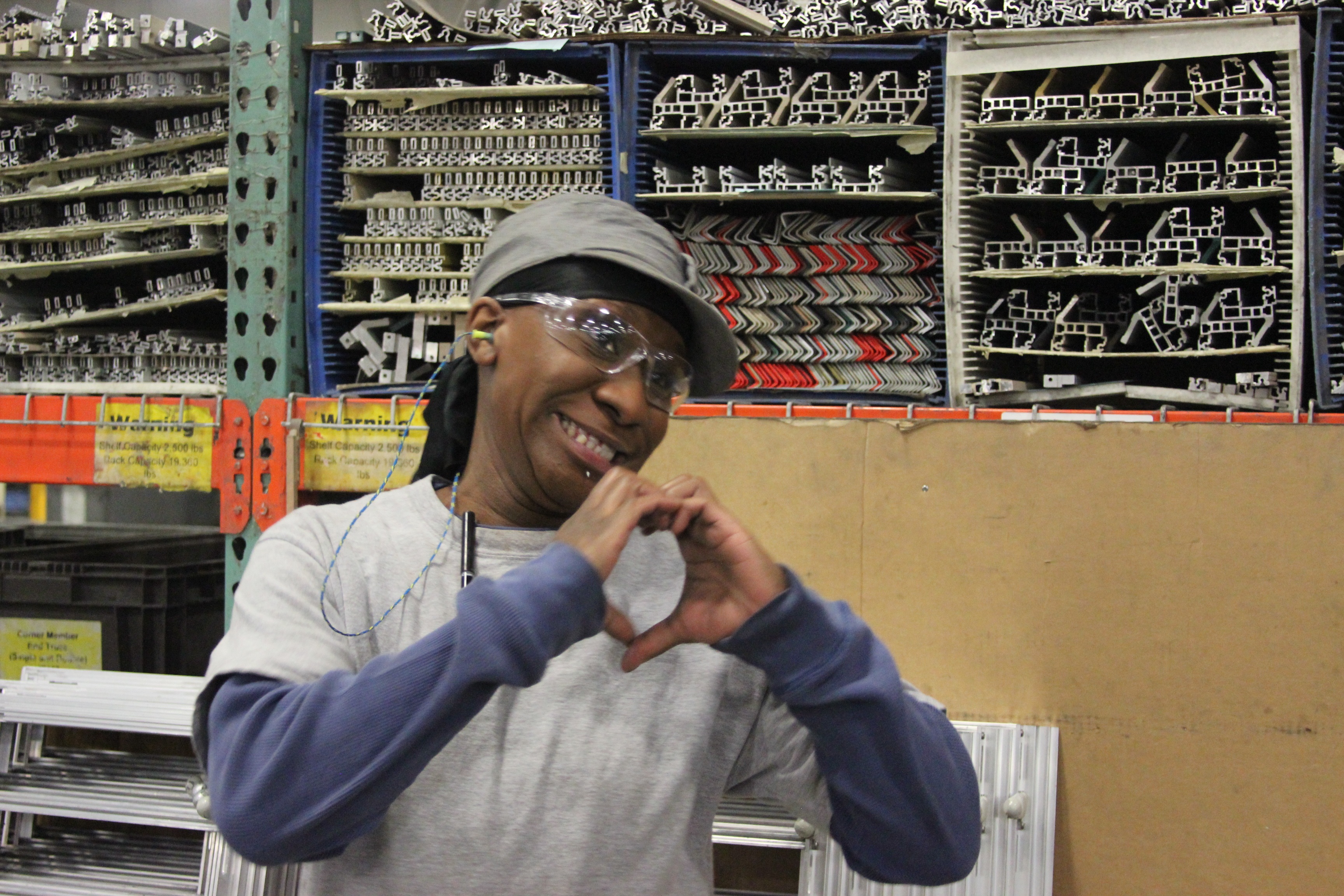 smiling worker making shape of heart with hands