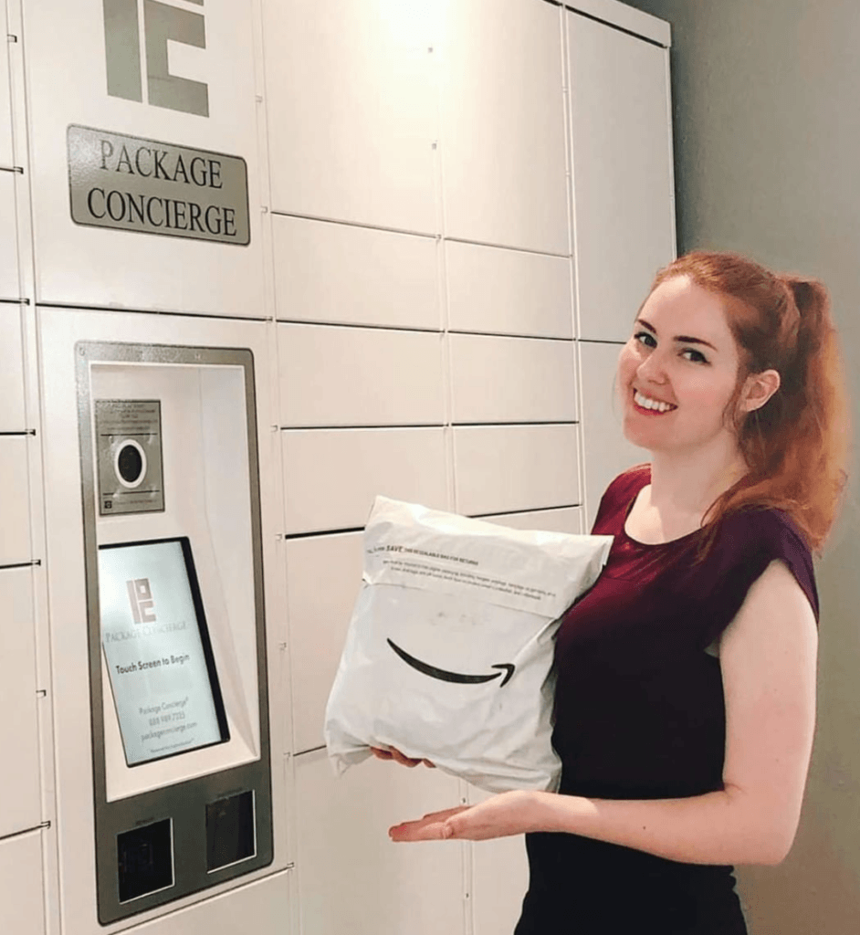 The Row A woman in a maroon shirt is holding an Amazon package in front of a Package Concierge® smart electronic parcel locker