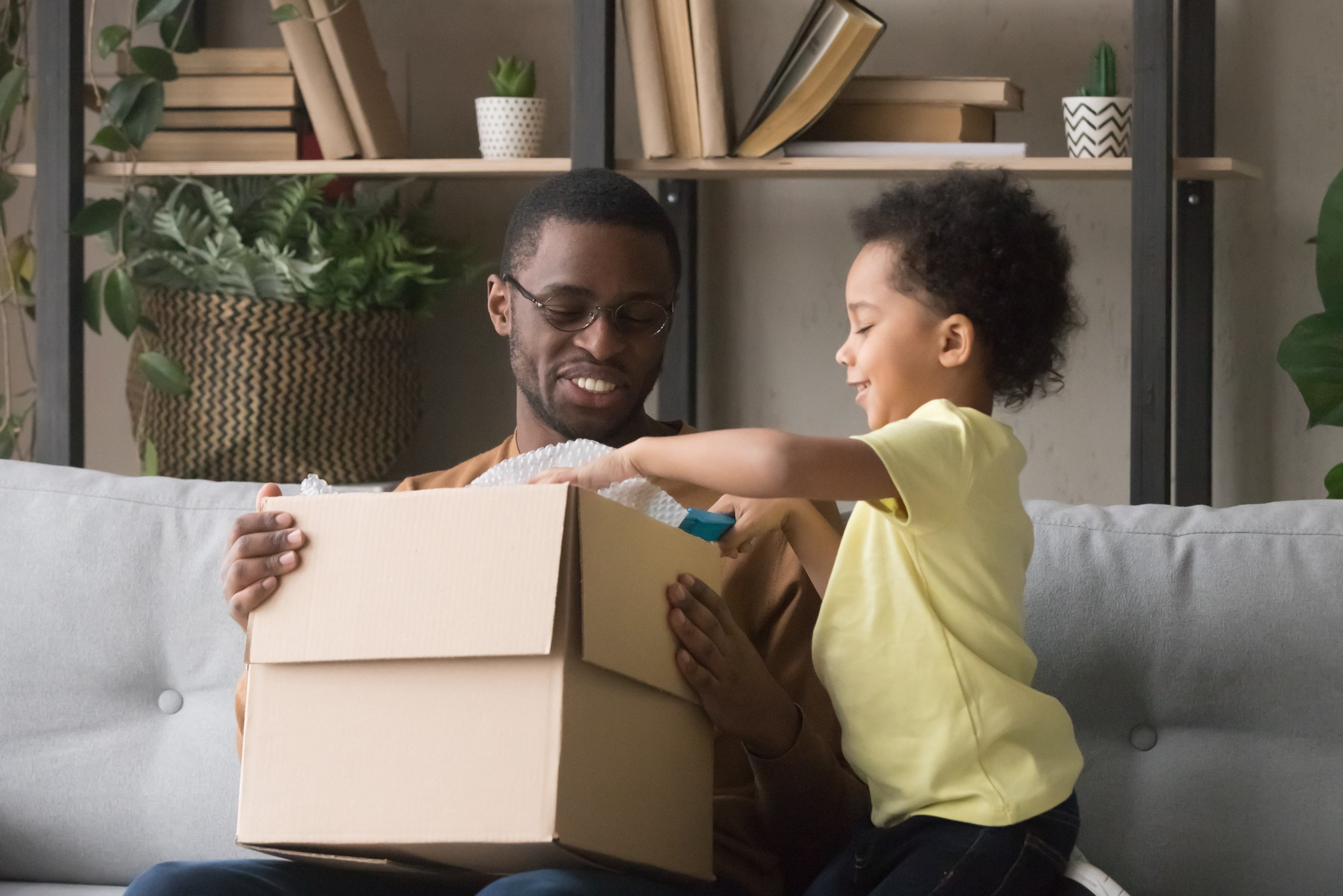 Father and son opening package